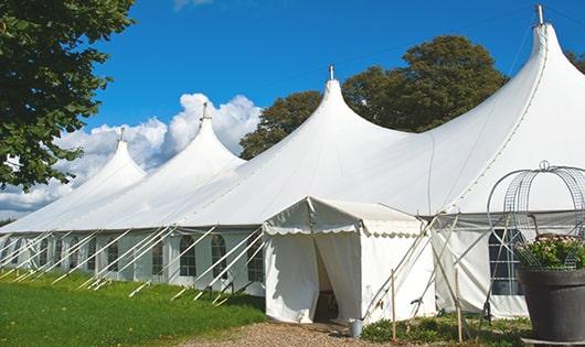 a line of sleek and modern portable toilets ready for use at an upscale corporate event in Milford, NH